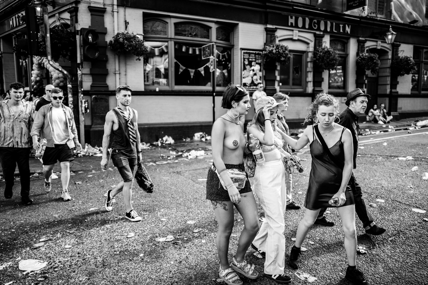 Friends helping a girl who has too much to drink across the road. Image © Nik van Herpt