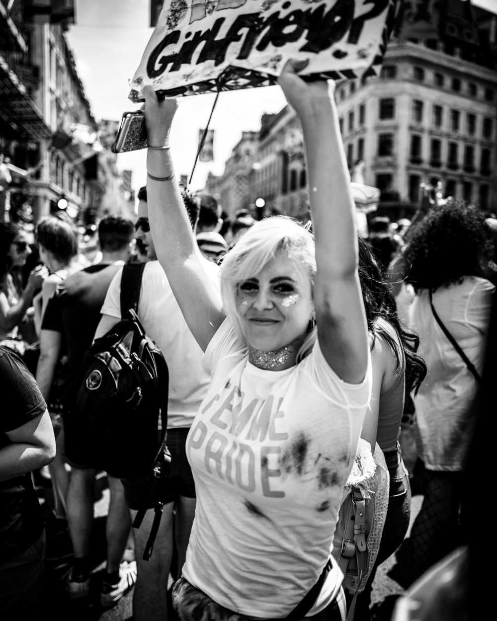 Girl in a Femme Pride t shirt waving a placard on Regent street. Image © Nik van Herpt