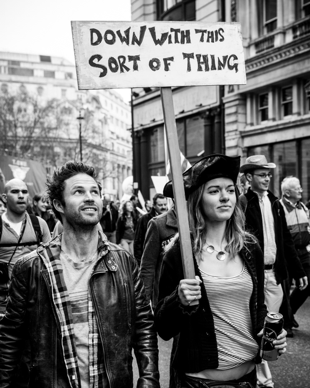 Woman holding “Down with this sort of thing” protest placard at the 2011 anti-cuts protest in London. Image © Nik van Herpt