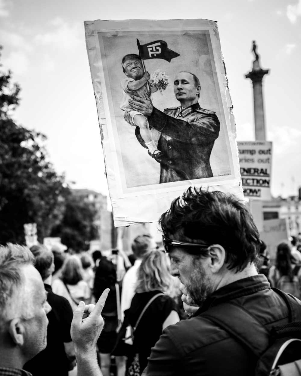 Baby Trump held up by Putin on a protest placard at the 2018 anti-Trump protest in London. Image © Nik van Herpt