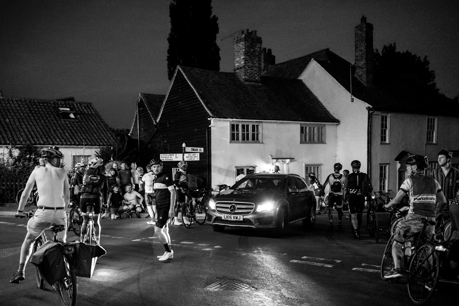 Car waiting pass through a crowd of cyclists. Image © Nik van Herpt