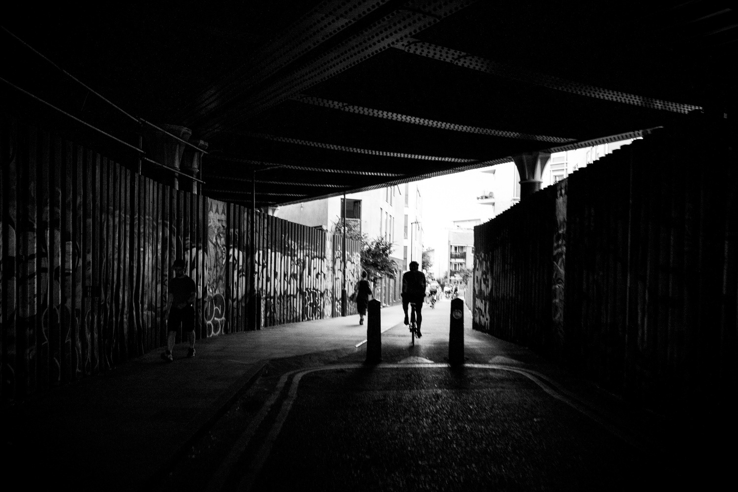 Cyclist passing underneath a railway bridge. Image © Nik van Herpt