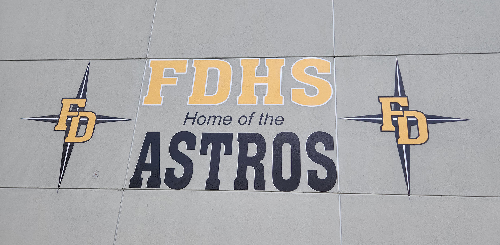 full print adhesive vinyl wall decal reading "FDHS Home of the Astros" with two FD four point star logos on either side
