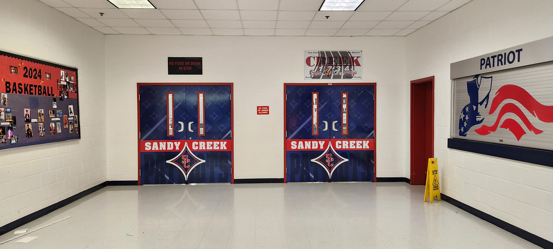 Red, white, and blue adhesive vinyl-covered door branded with an SC logo and the text "Sandy Creek Patriots"