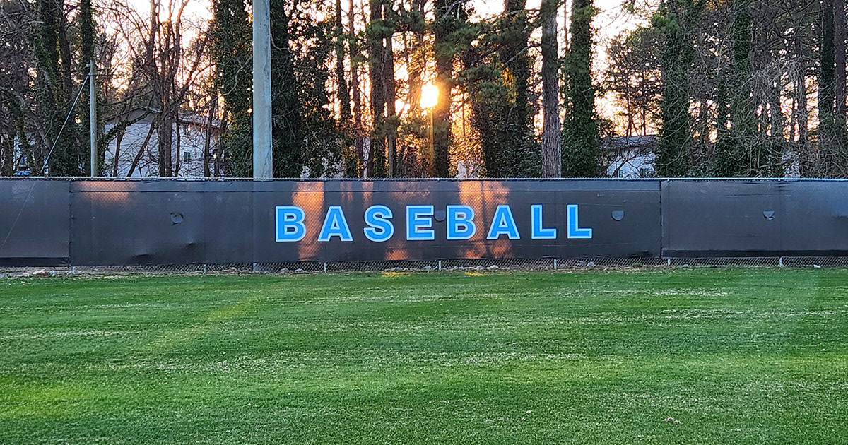 black fence windscreen printed with blue lettering outlined in a lighter shade of blue reading 'baseball'