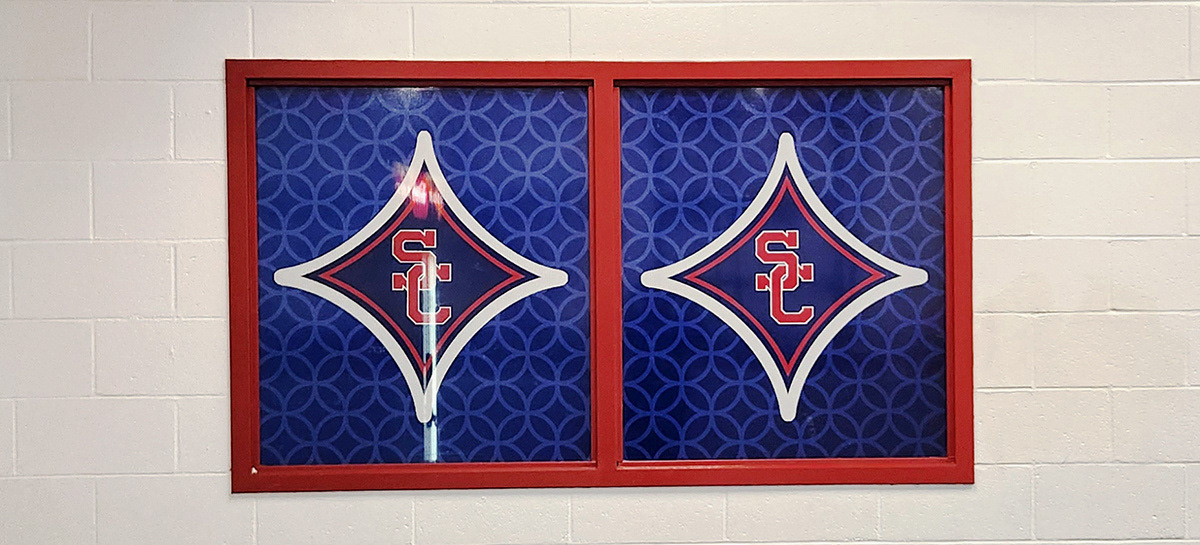 A full print red, white, and blue window perforation branded with a SC logo
