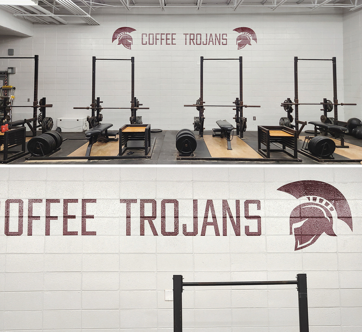 A weight room with a painted white brick wall featuring adhesive vinyl decals. The decals display two Trojan helmet silhouettes facing each other, with the words 'COFFEE TROJANS' positioned in the middle.