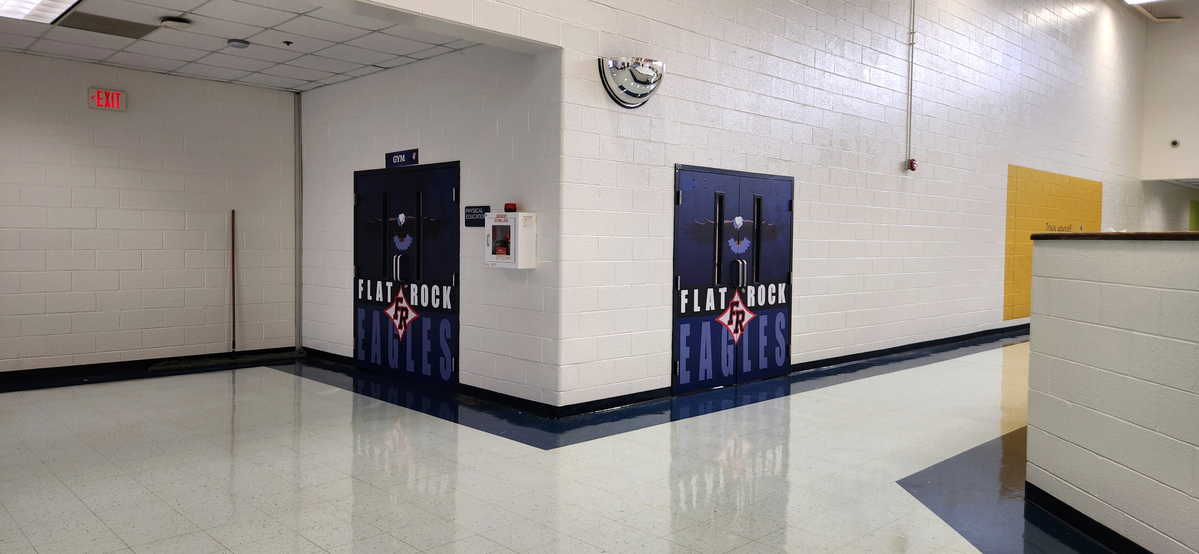 Two doors with printed vinyl wraps showing the school name and eagle mascot, easily visible from several feet away.