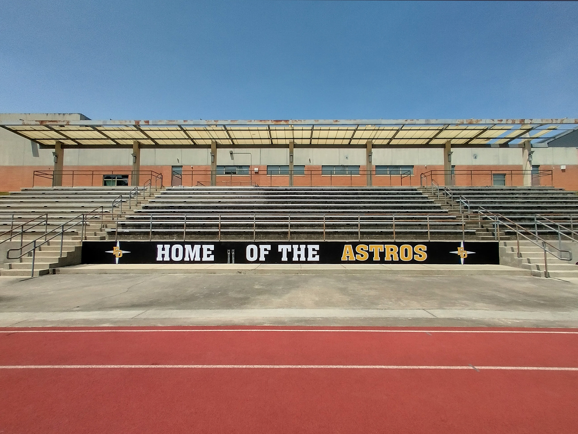 black fence windscreen printed with twp white four point star logos with 'FD' in yellow over them, and the text 'home of the Astros' printed between