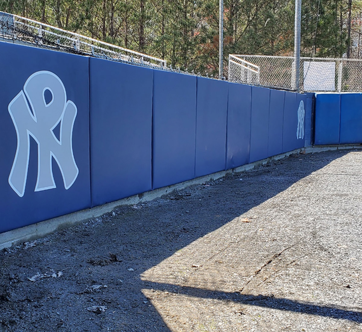 wall padding covered in navy blue sports vinyl branded with NP logo