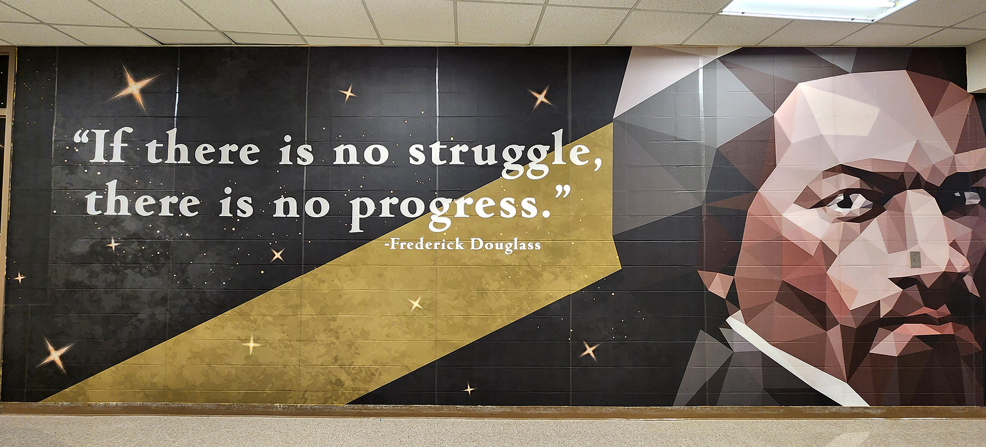 full print adhesive vinyl wall mural and window perf printed with gradient white and yellow stars on an all black background underneth a quote printed in white reading "if there is not struggle, there is no progress – Fredrick Douglass" next to a cubist image of Fredrick Douglass