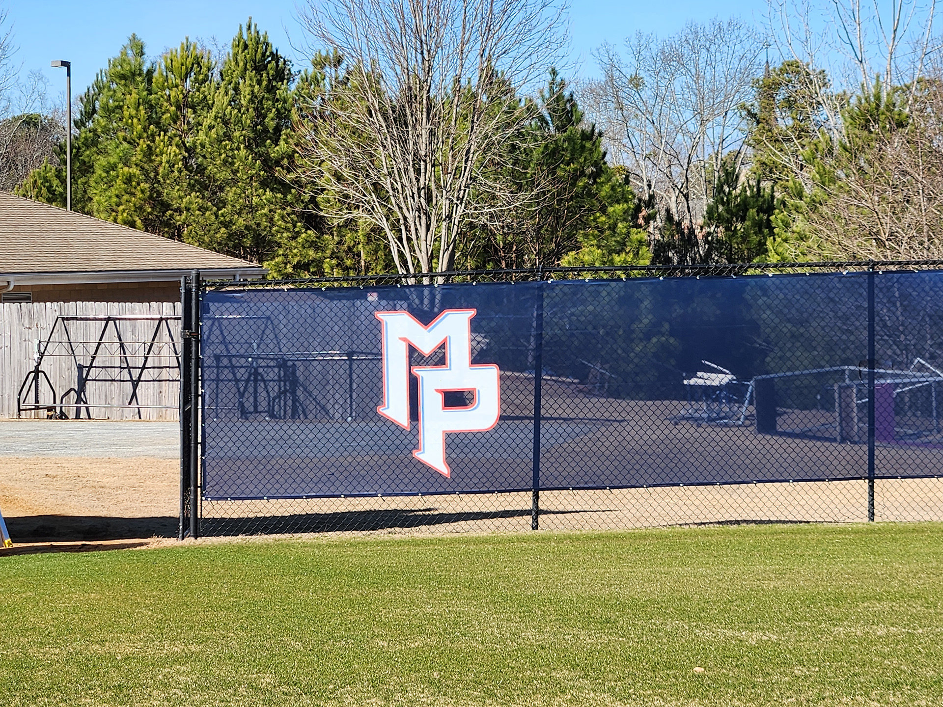 blue fence windscreen with a white logo accented in blue with red outline reading 'MP' printed on it