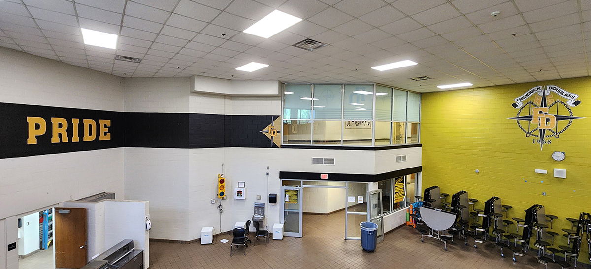 a full print adhesive banner black with yellow lettering with a white outline reading 'astro pride' and black four point star outlined in white over a tan triangle and under yellow lettering with a white outline reading 'FD'