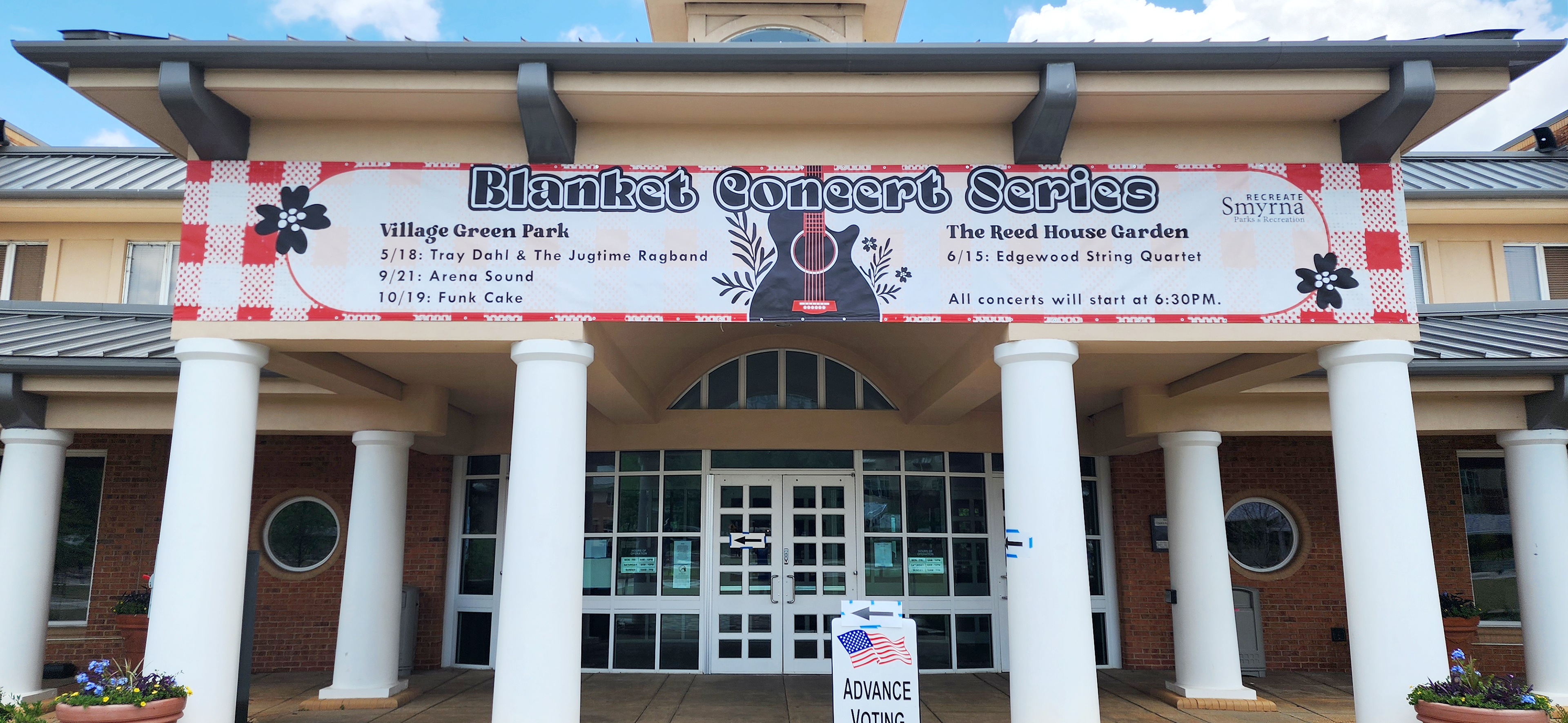 Printed vinyl banner for a concert series affixed to the front entrance of a building.