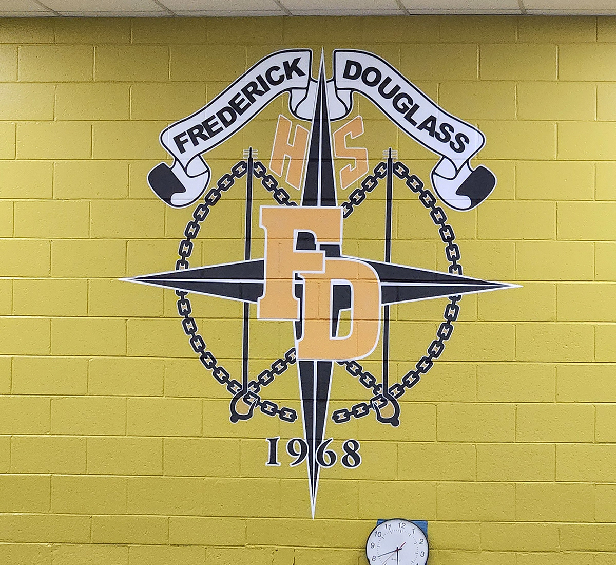 full print adhesive cutout decal with a black four point star with a white ouline under yellow text with a white outline reading 'HS' at the top and 'FD' in the middle, all set below a white banner with black text over it reading 'Fredrick Douglas'