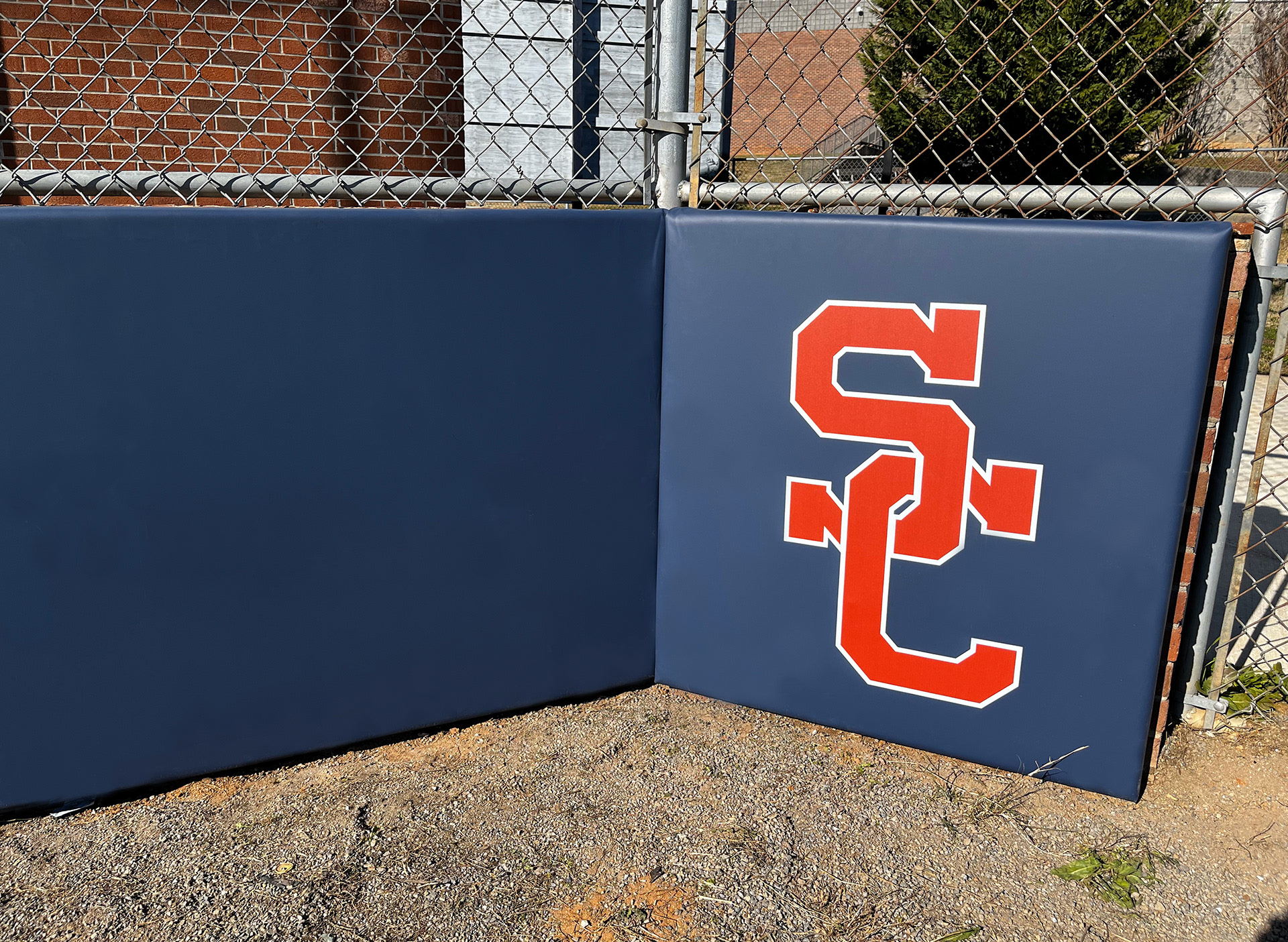 Navy blue vinyl-covered padding featuring a red SC logo on the far right side