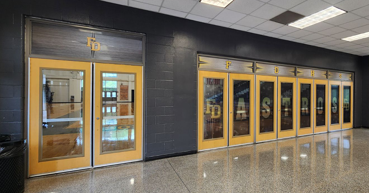 full print window perf with a grey background under a black four point star outlined in white under yellow lettering with a white outline reading 'FD' and 'FDHS' above the doors, and 'FD' 'ASTROS' 'FD' on the doors