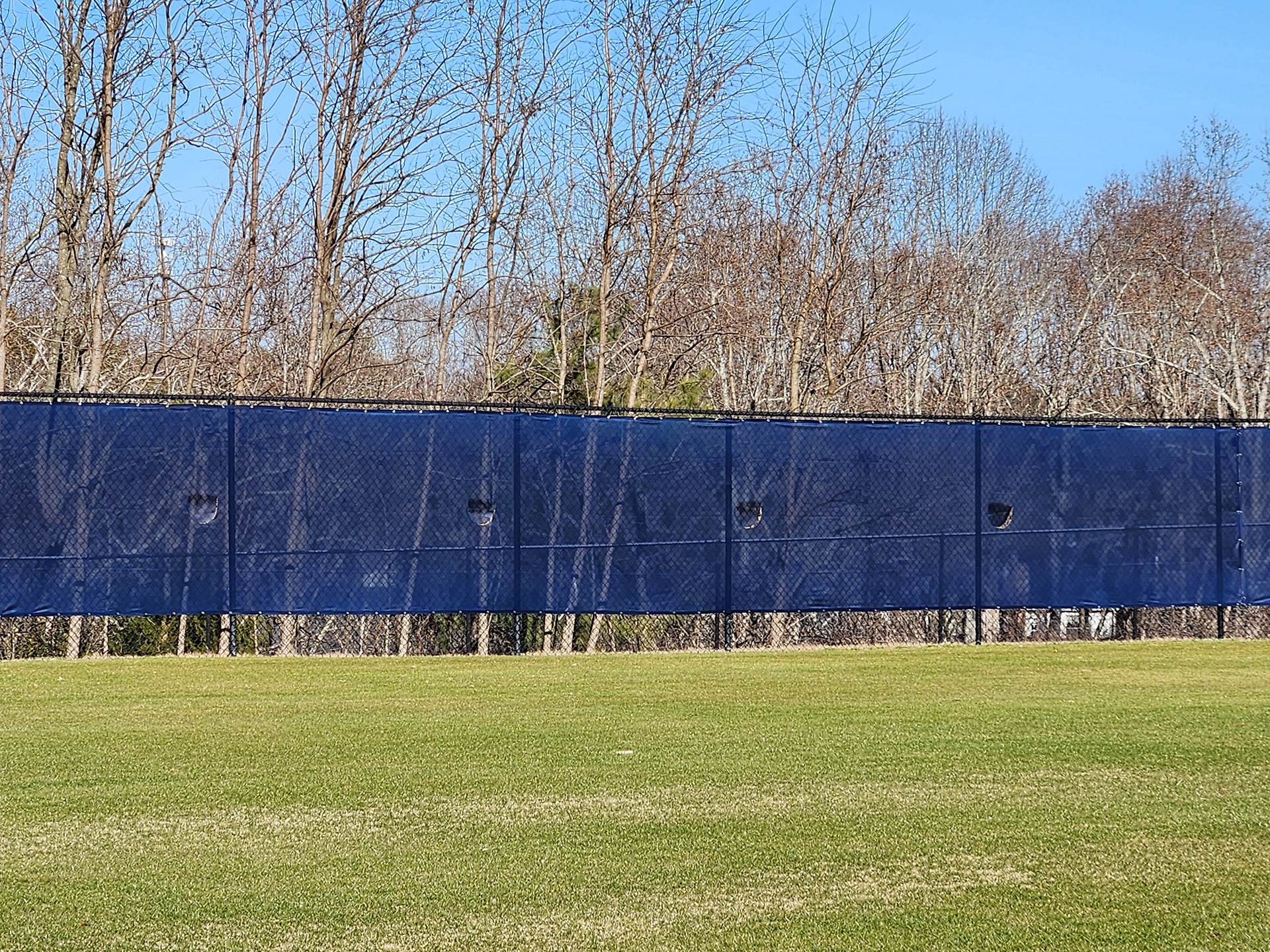 blue fence windscreen with half moon vents