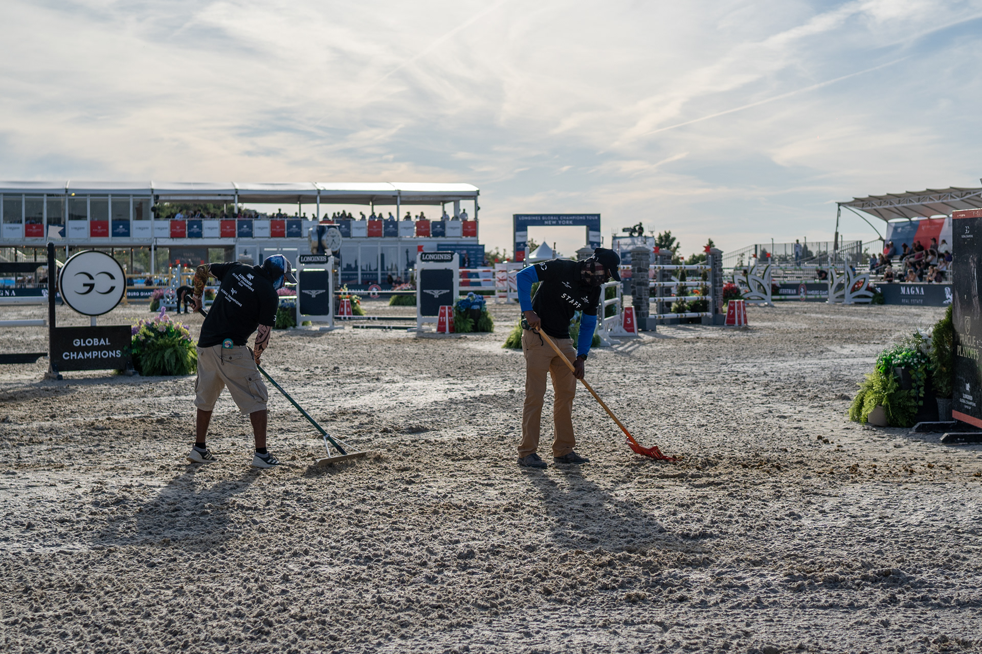 Governer’s Island, New York — September 27, 2019. Longines staff rake the ground after each horse completes their turn.
