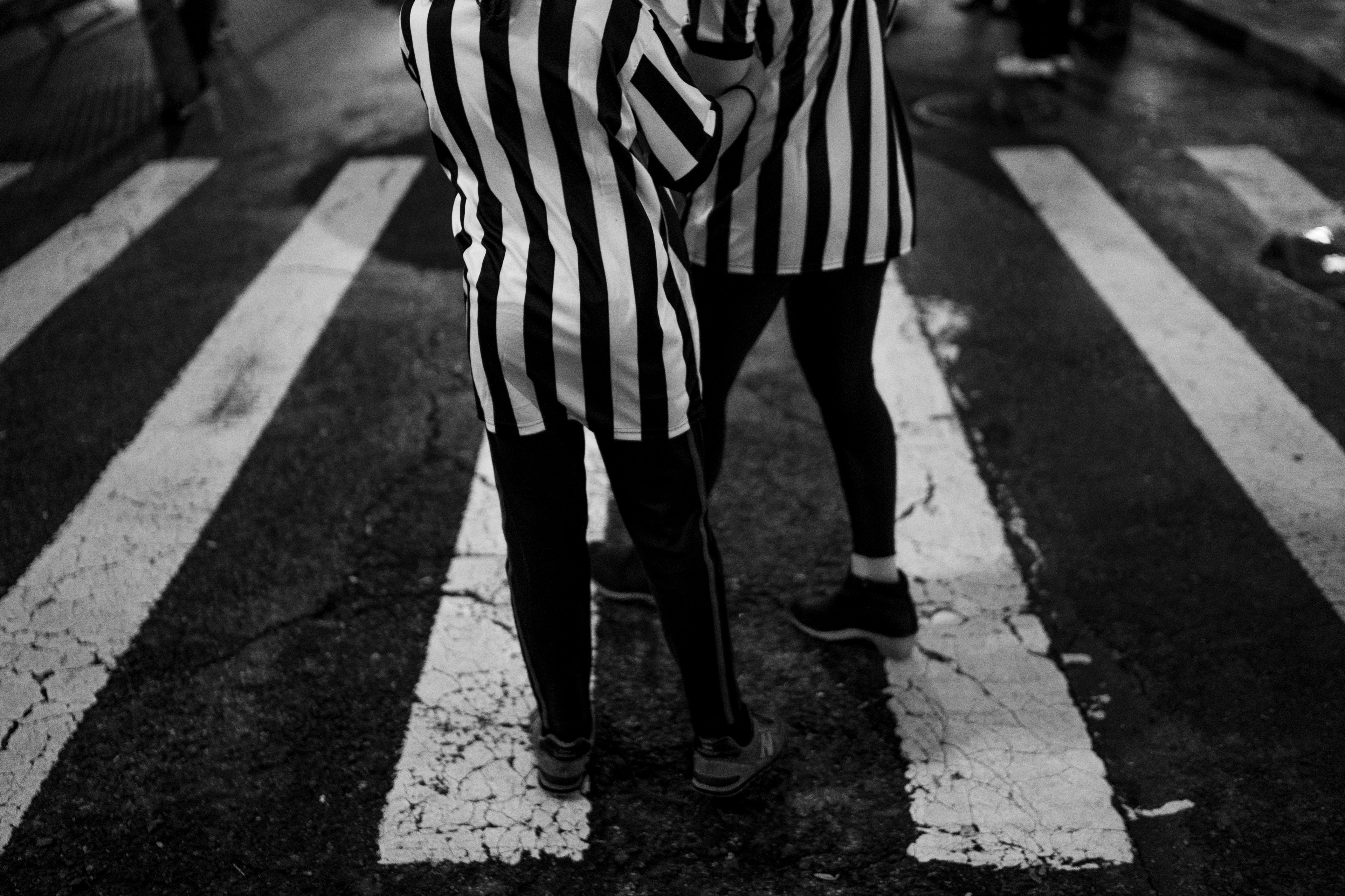 Village Halloween Parade — New York, NY. October 31st, 2019. A couple of referees at the crosswalk.