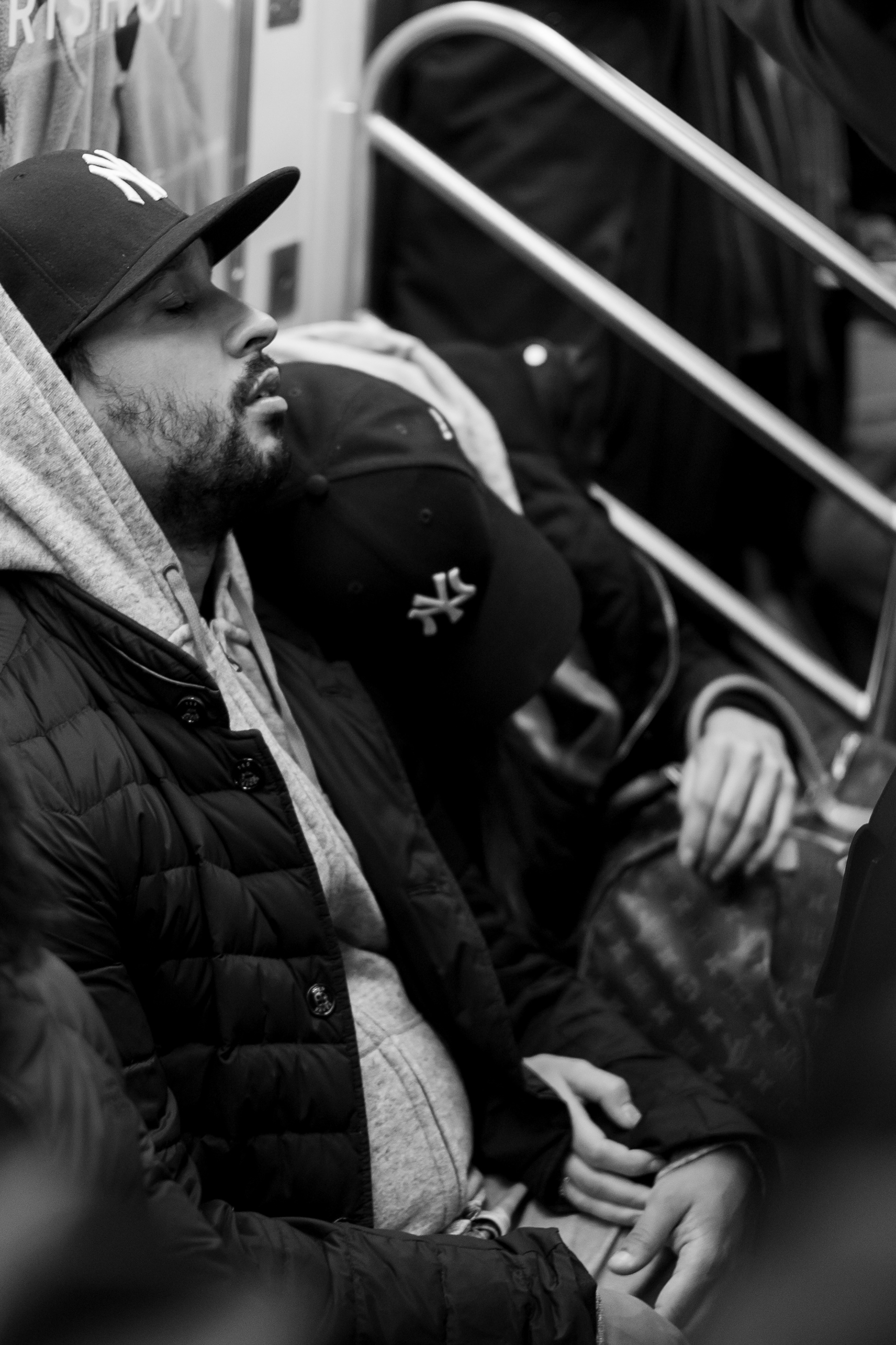 Bronx, New York — October 18th, 2019. Yankees couple on the 4 train after the game.