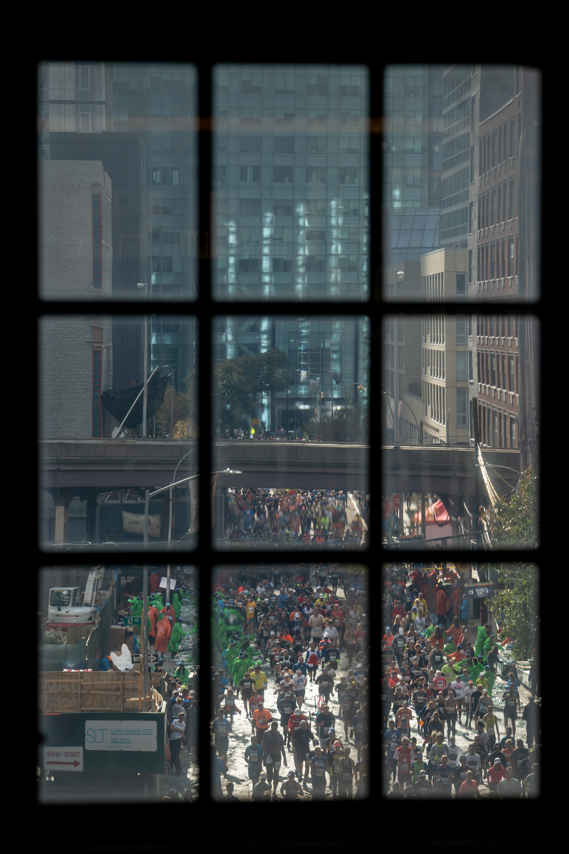 NYC Marathon — New York, NY. November 3rd, 2019. Runners on Crescent Street in Queens — view from the Queensboro Plaza subway stop.