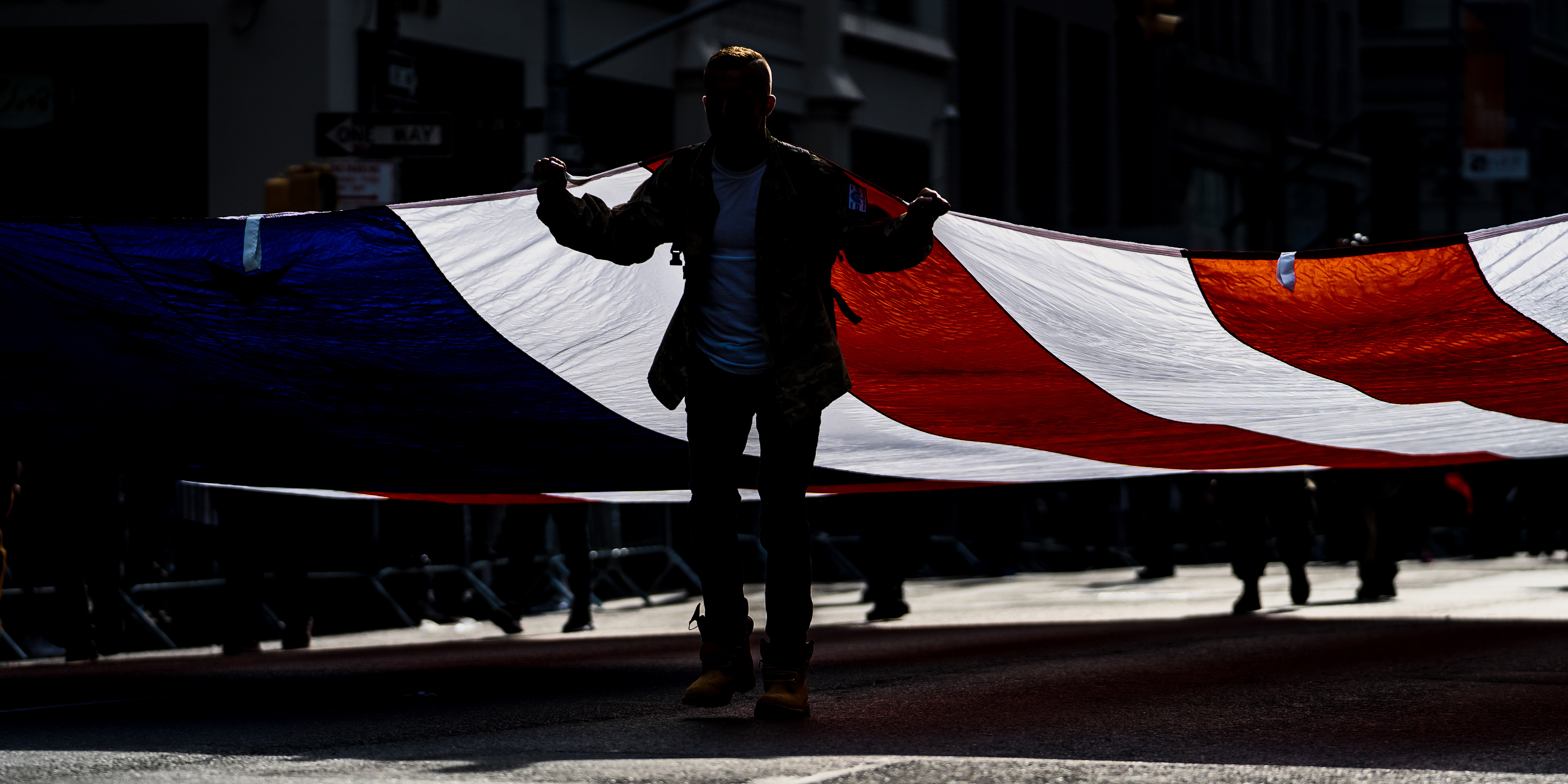 2019 Veterans Day Parade — New York, NY, 11/11/19. Veterans pull a large US flag in the Veterans Day parade.