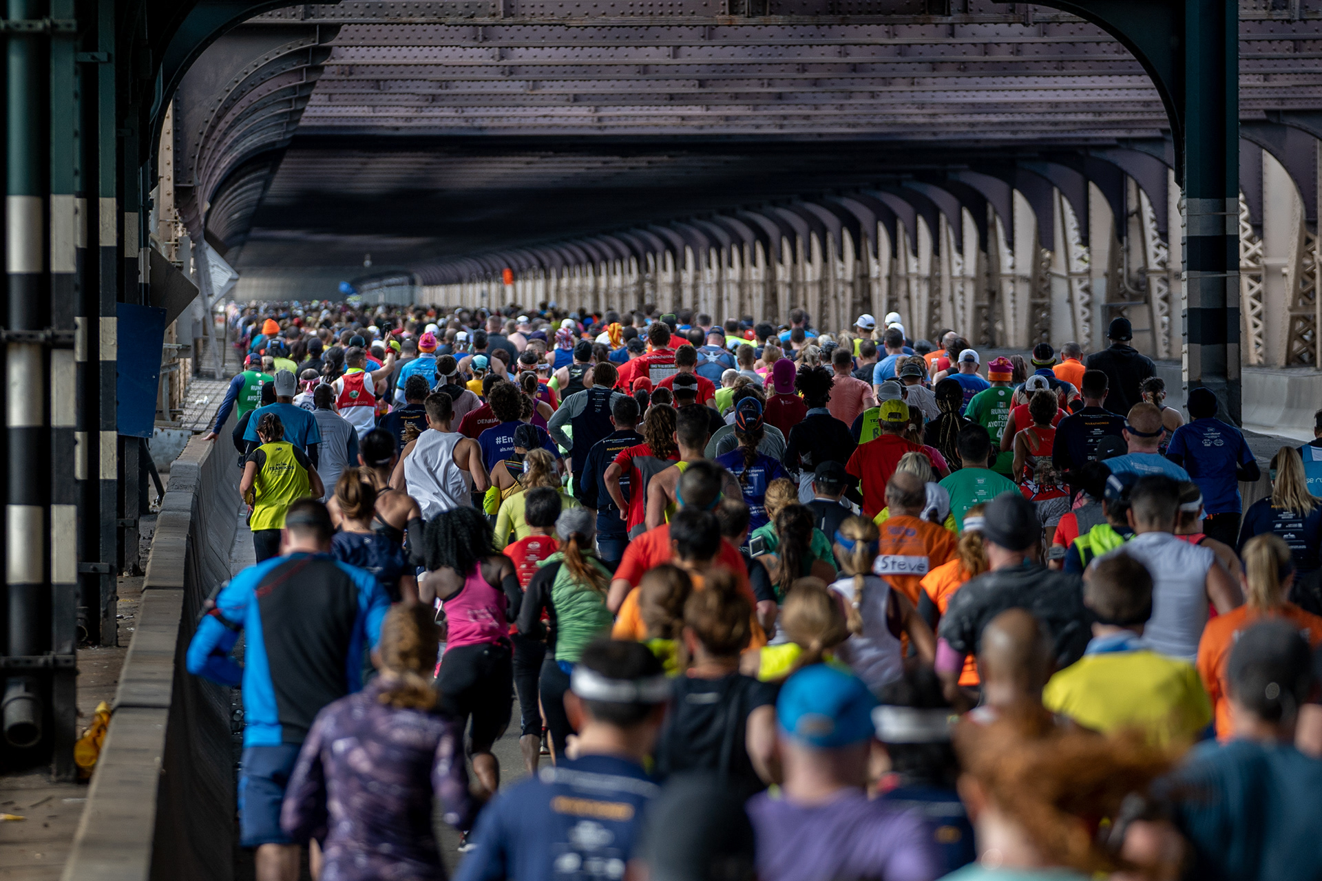 NYC Marathon — New York, NY. November 3rd, 2019. Runners running towards Manhattan on the Queensboro Bridge.
