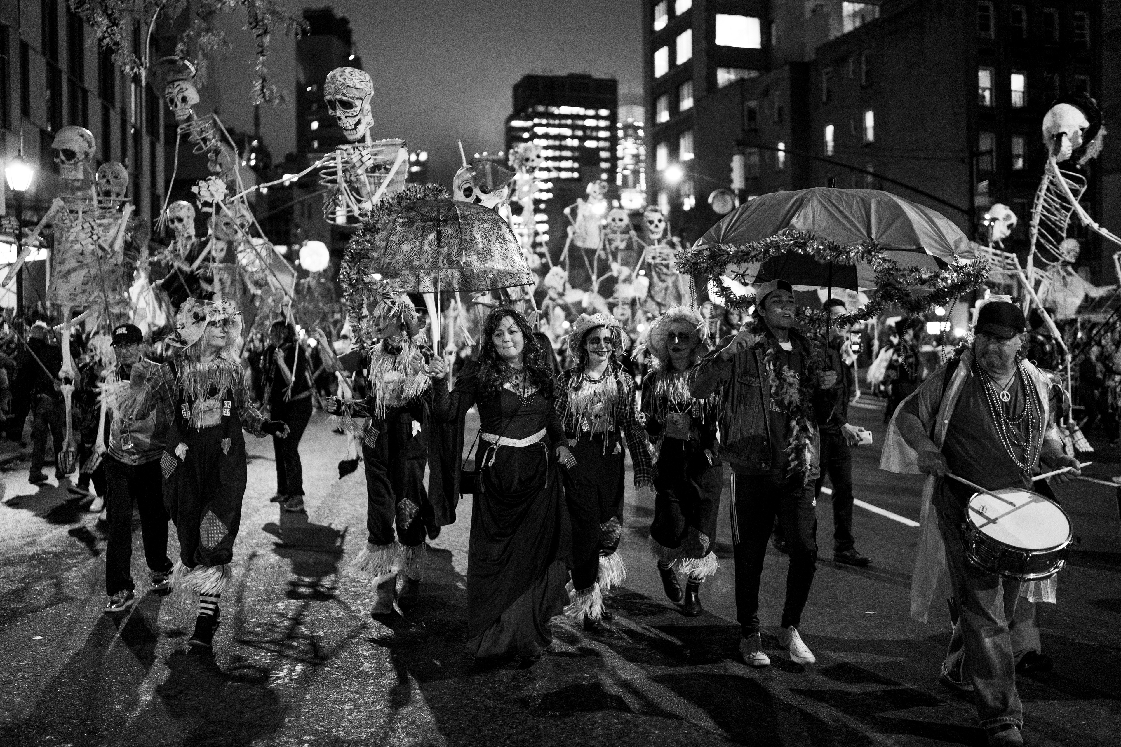 Village Halloween Parade — New York, NY. October 31st, 2019. A group carries full-sized skeleton marionettes through the parade.