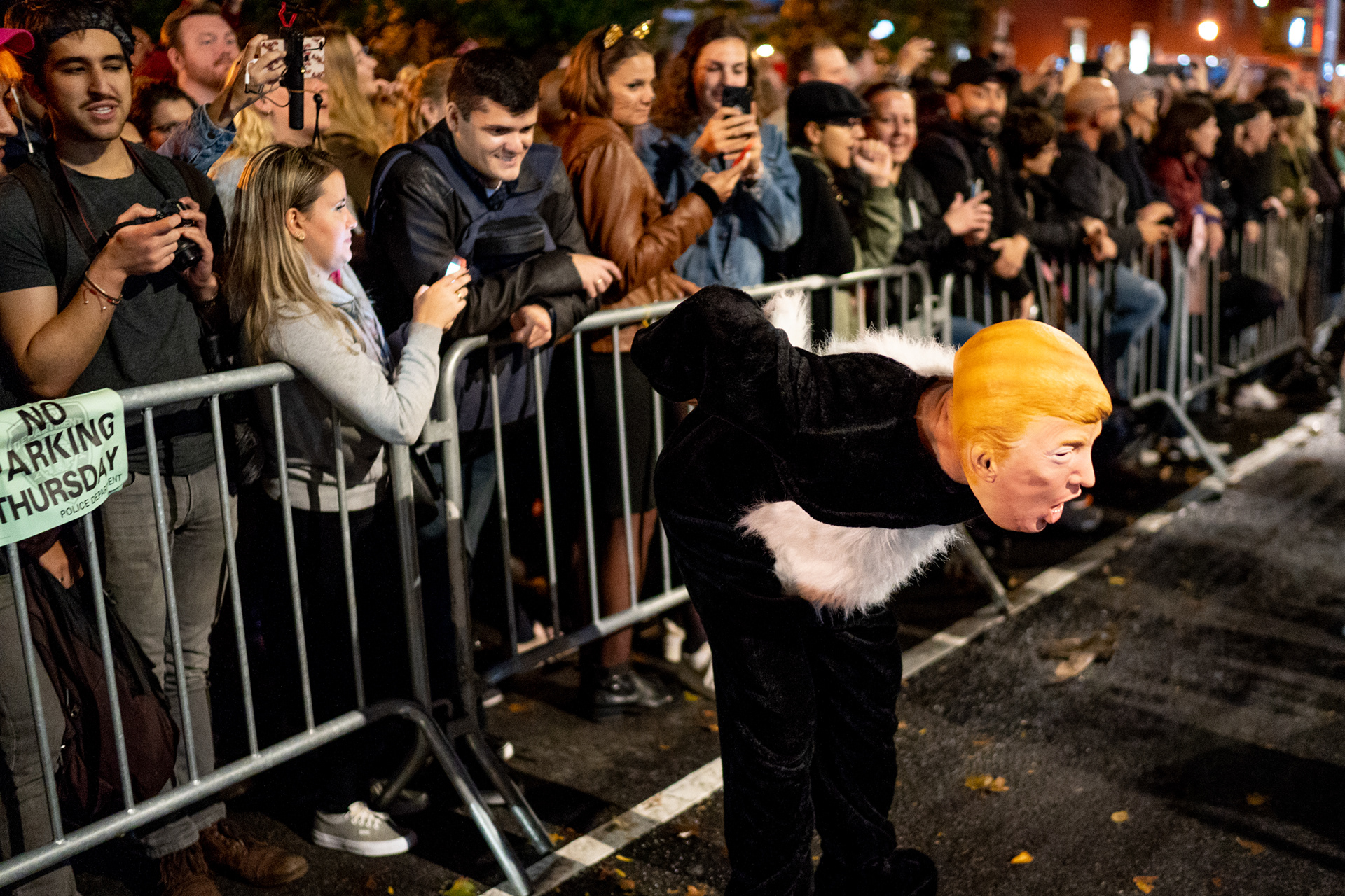Village Halloween Parade — New York, NY. October 31st, 2019. A Trump skunk flashes the crowd.