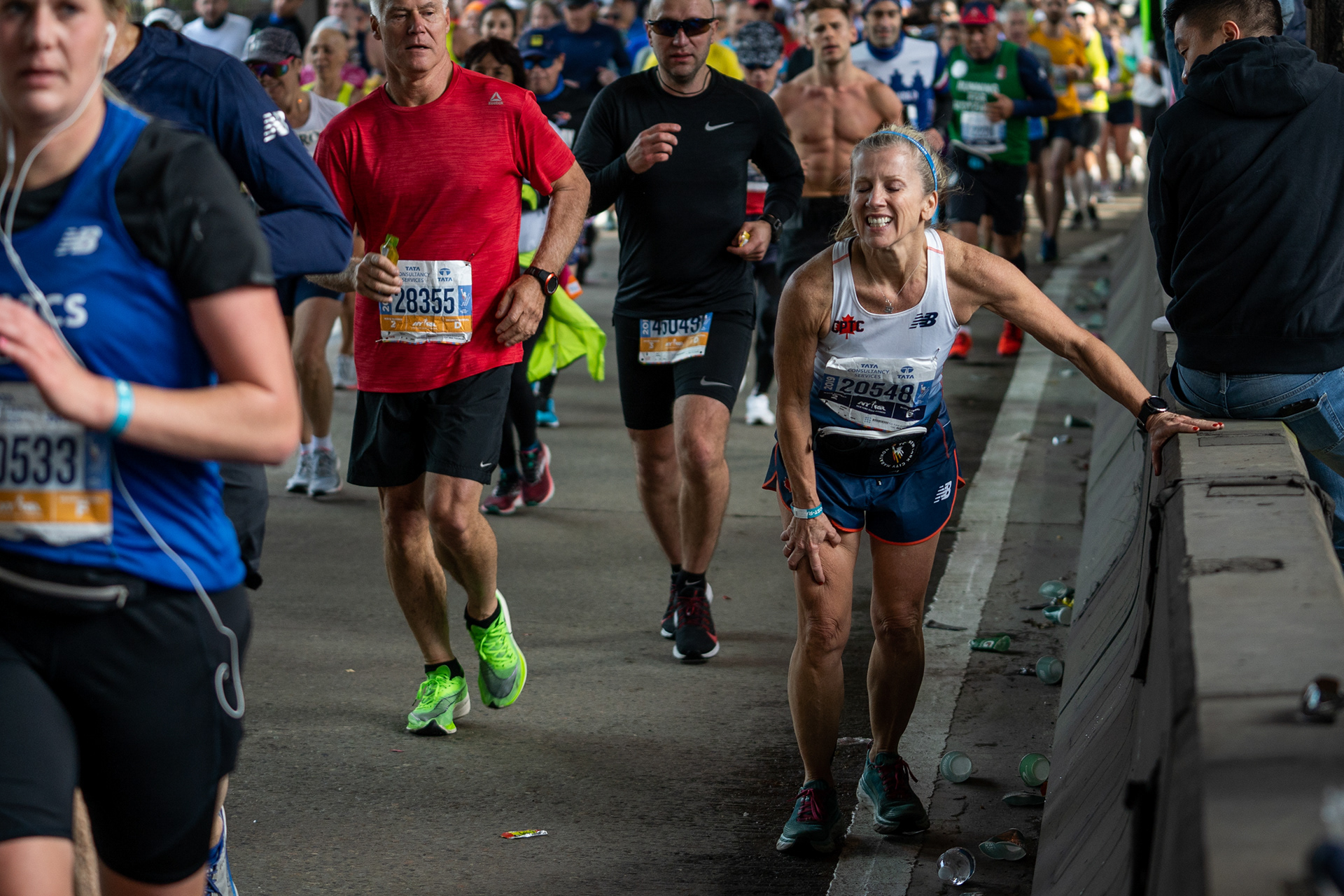 NYC Marathon — New York, NY. November 3rd, 2019. Jeannine Antus (60) takes a break on the Queensboro Bridge.