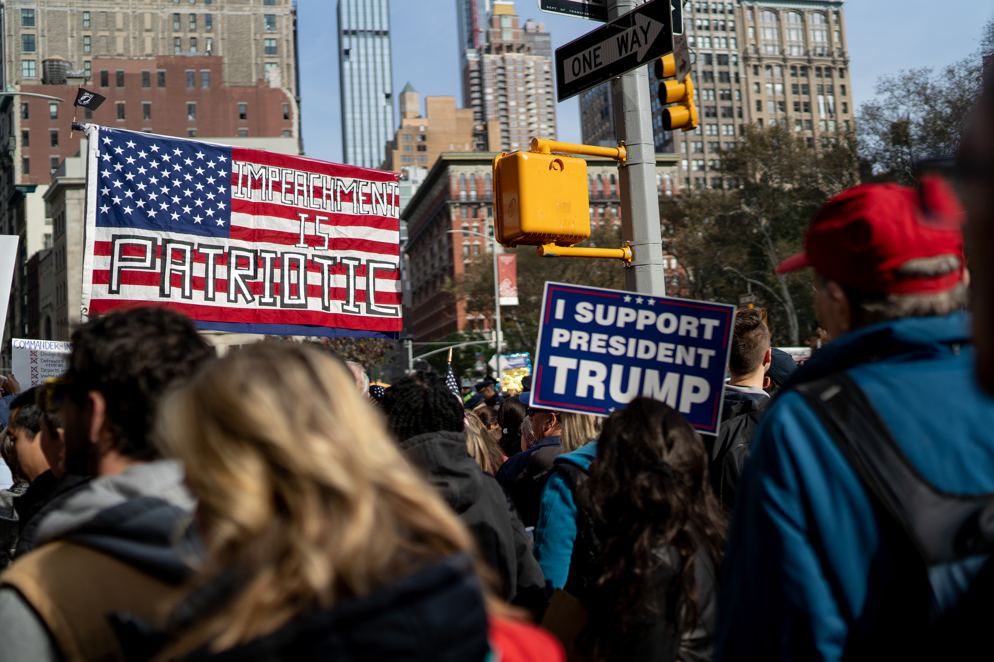 2019 Veterans Day Parade — New York, NY, 11/11/19. Conflicting signs at the southern part of the parade route.