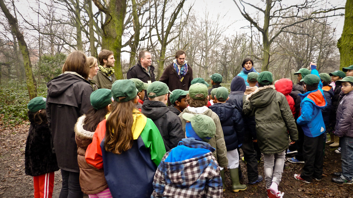 Photograph of educators explaining activity to children using the toolkit