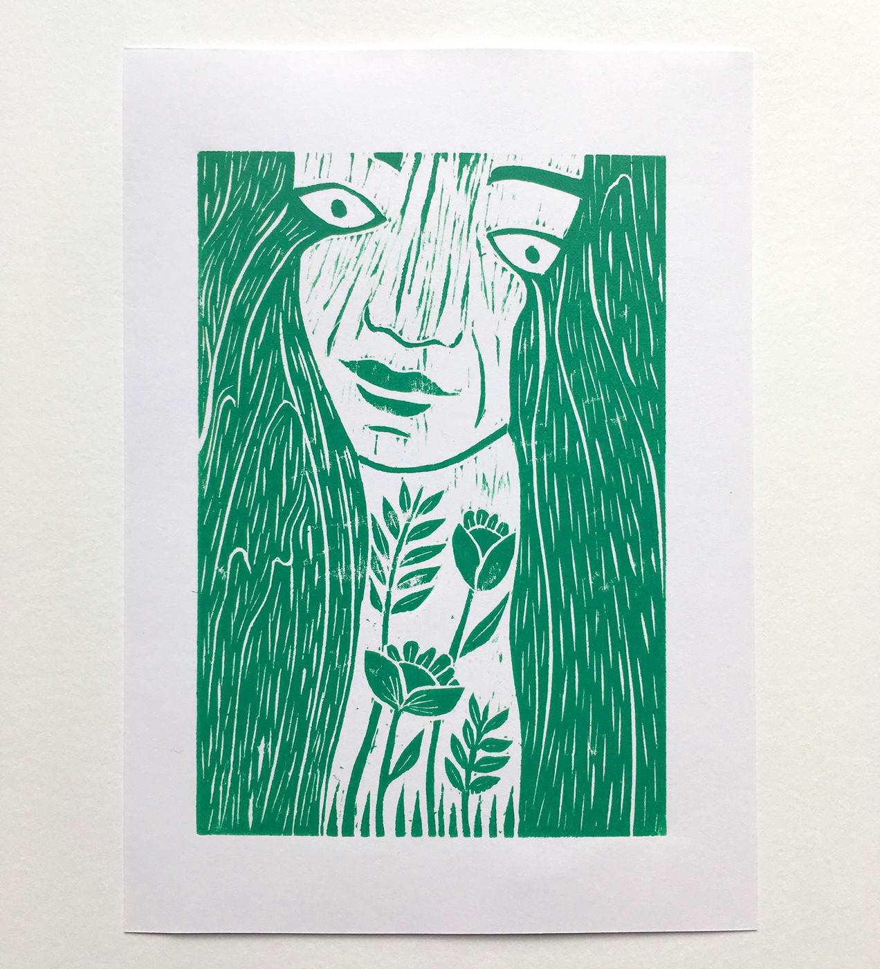 Woodcut print. Woman crying tears as waterfalls. Printed in teal on white.