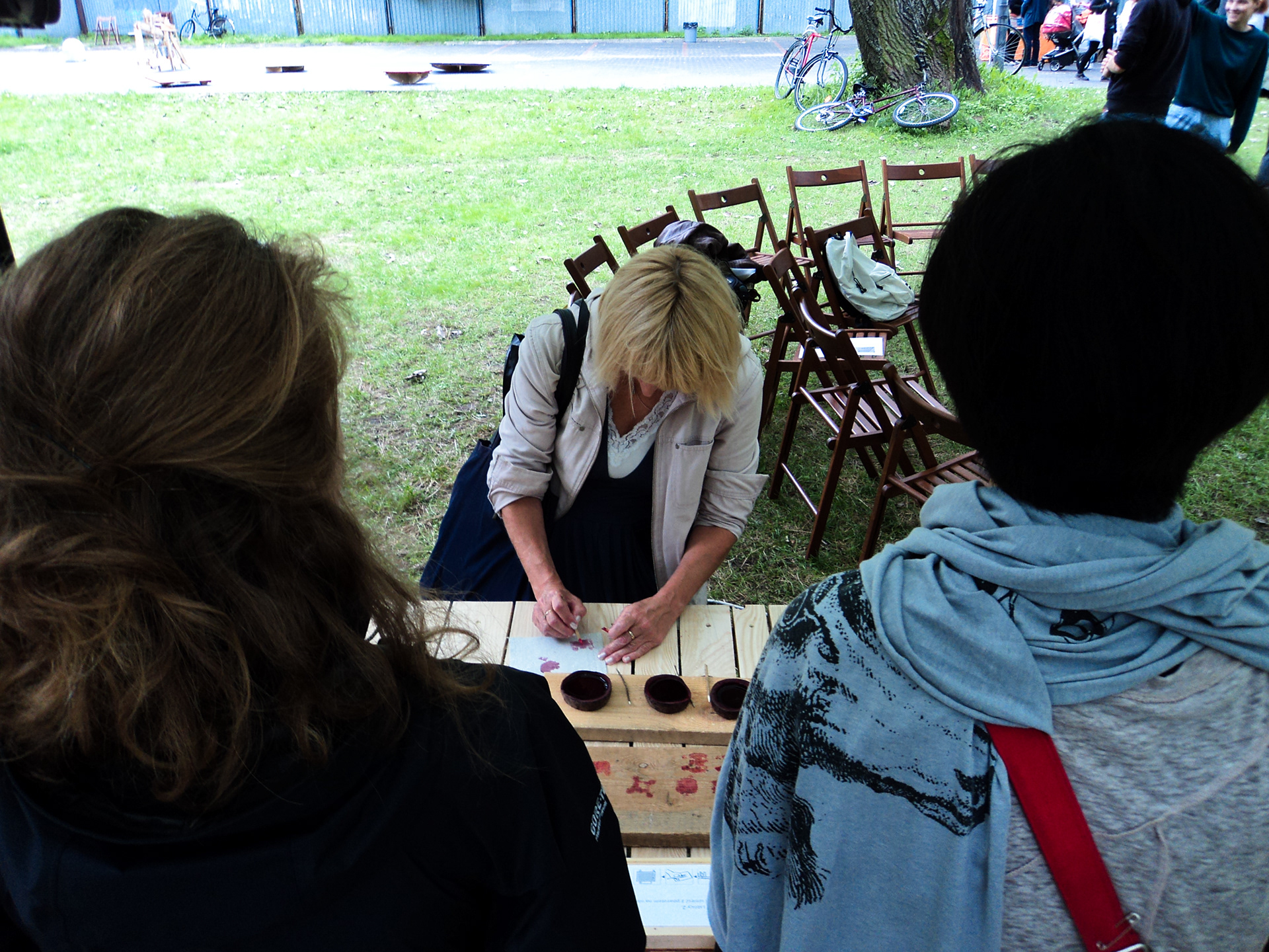 Photograph of person writing a story using the beetroot ink 2