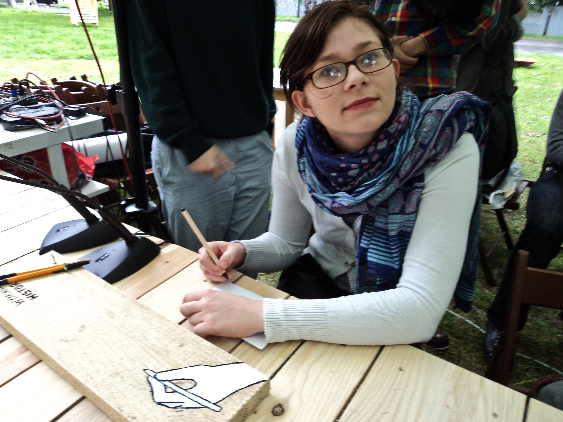Photograph of person writing her address on an envelope