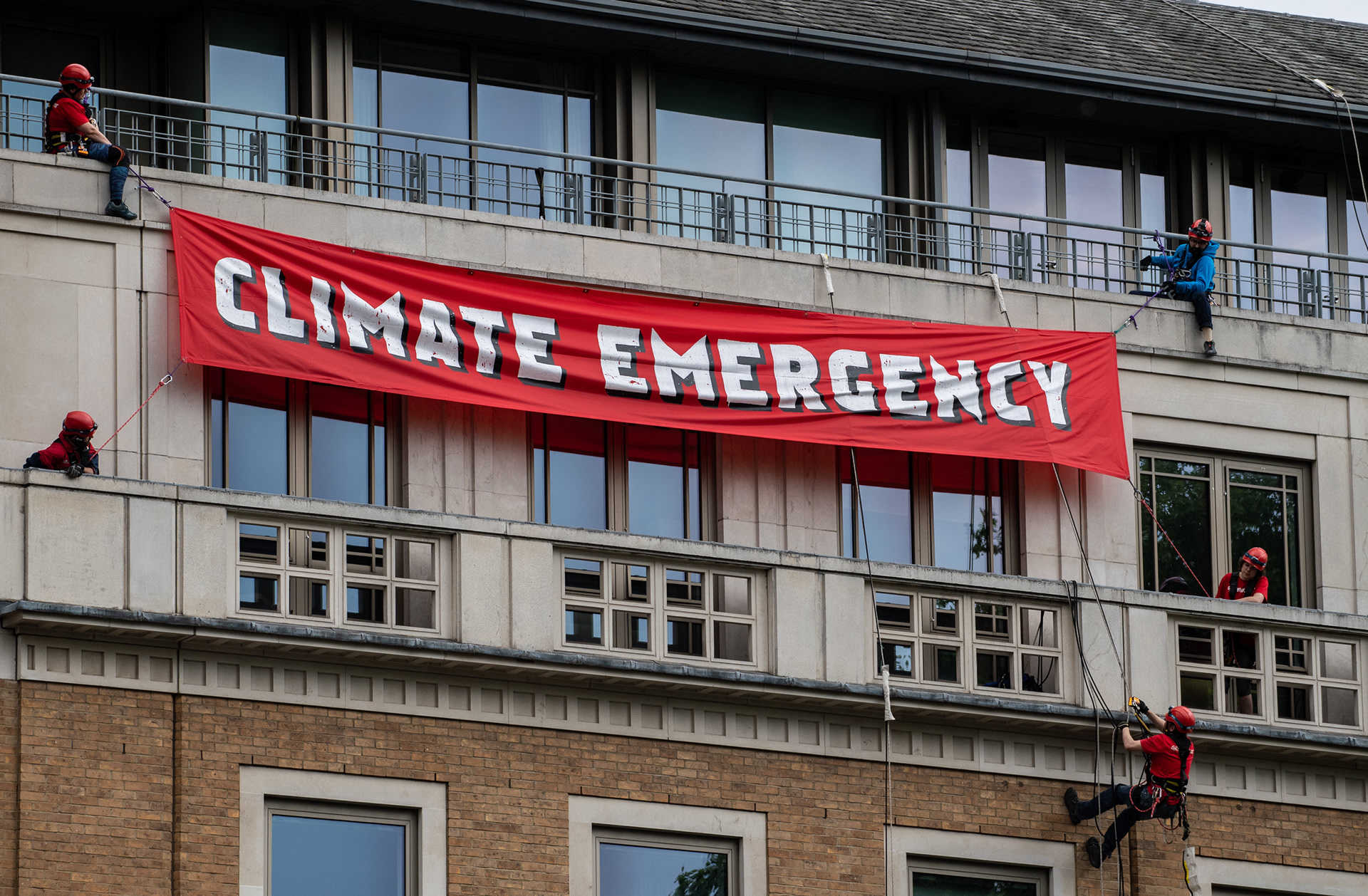 Campaign banner reading 'Climate Emergency' is hung outside BP's HQ