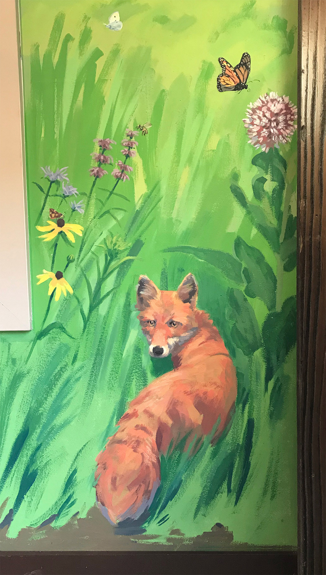 Red fox with native wildflowers and butterflies.