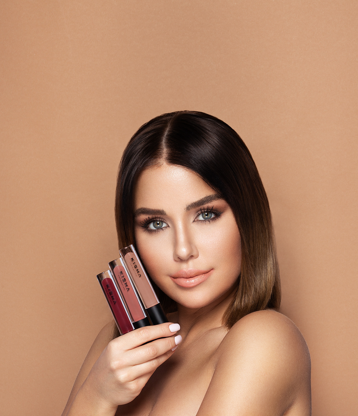 Beautyfotografie, Portrait, Kim Gloss, Campaign, Lächeln, brauner Hintergrund, Lippgloss in der Hand