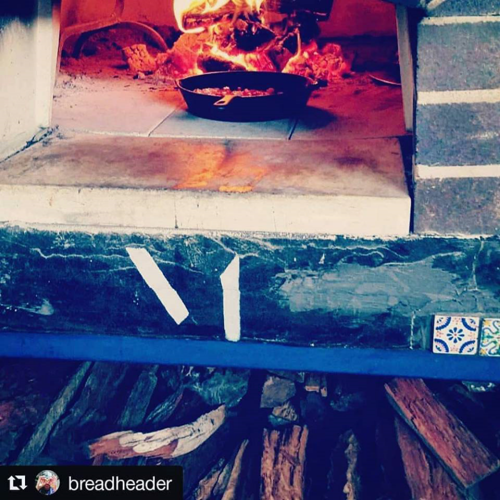 Logo on custom pizza oven inside the shop