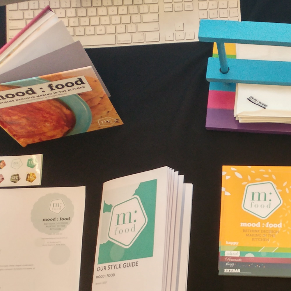 Stickers, letter head, style guide, flyer, napkin holder, book itself, stamped nakins
