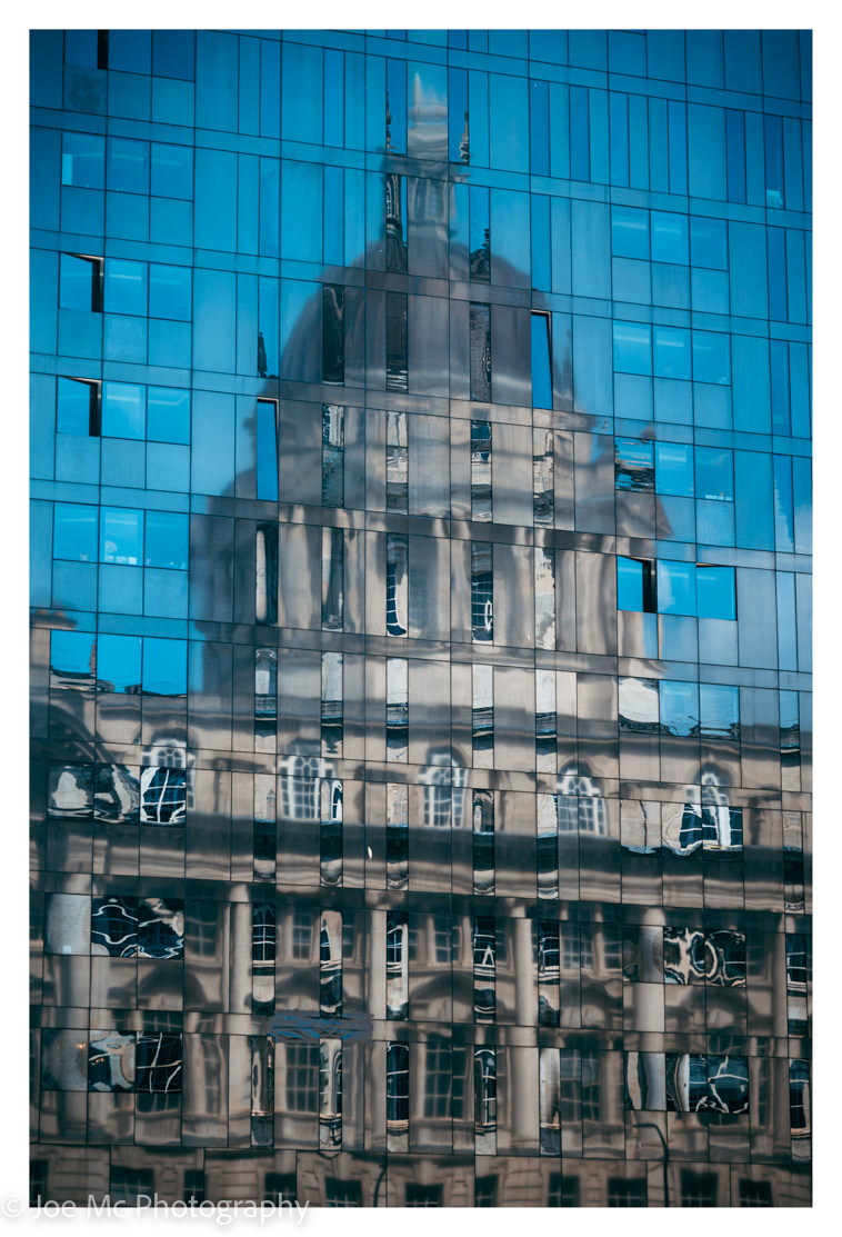 The Port of Liverpool Building reflected in the windows of Mann Island, Liverpool UK