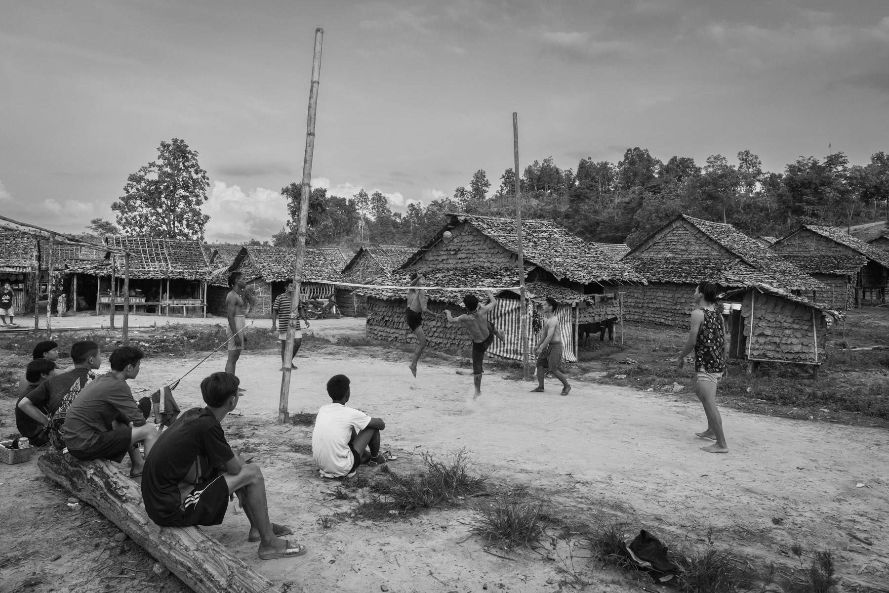 Karen youth playing Chinlone, a Burmese traditional kick-volley played with a small rattan ball. Lae Gho IDP Camp, Kayin, Myanmar, June 2022