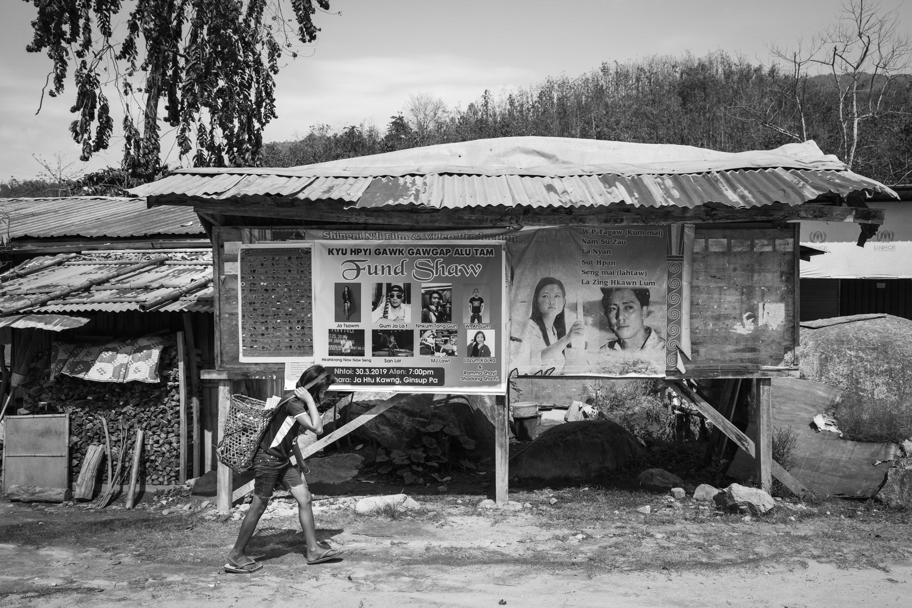 A Kachin girl carrying supplies in Je Yang IDP camp in Kachin Independence Army controlled territory. The KIA territory is landlocked between China and the frontline making it extremely difficult for humanitarian aid and food to reach this remote conflict zone in Northeastern Myanmar. Je Yang, Laiza, Myanmar, April 2019