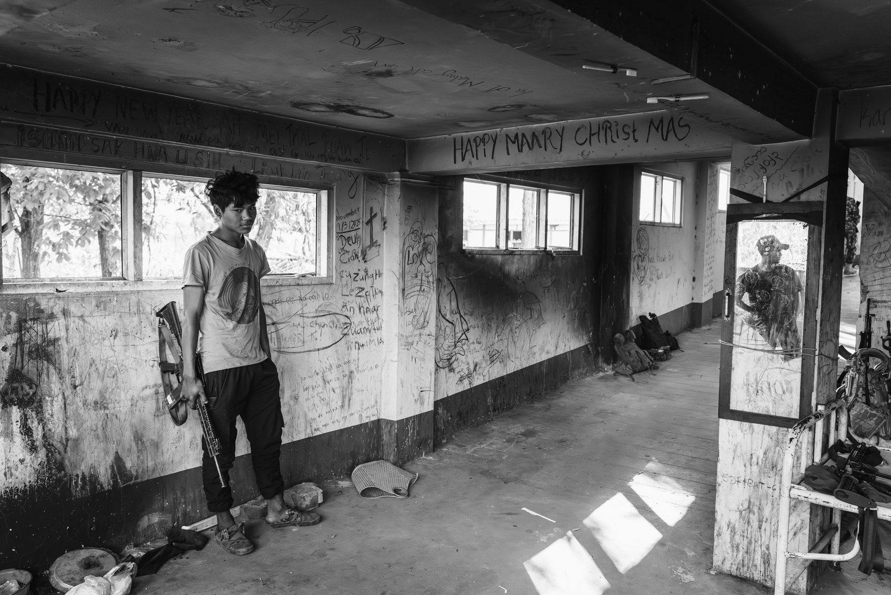 Member of the Chin Defense Forces (CDF) on the frontline in the hospital facing the Myanmar military positions. The town has been emptied of its civilian population and is since then bitterly fought over. At this stage both sides control more or less 50% of Thantlang. Thantlang hospital, Chin State, Myanmar, April 2024