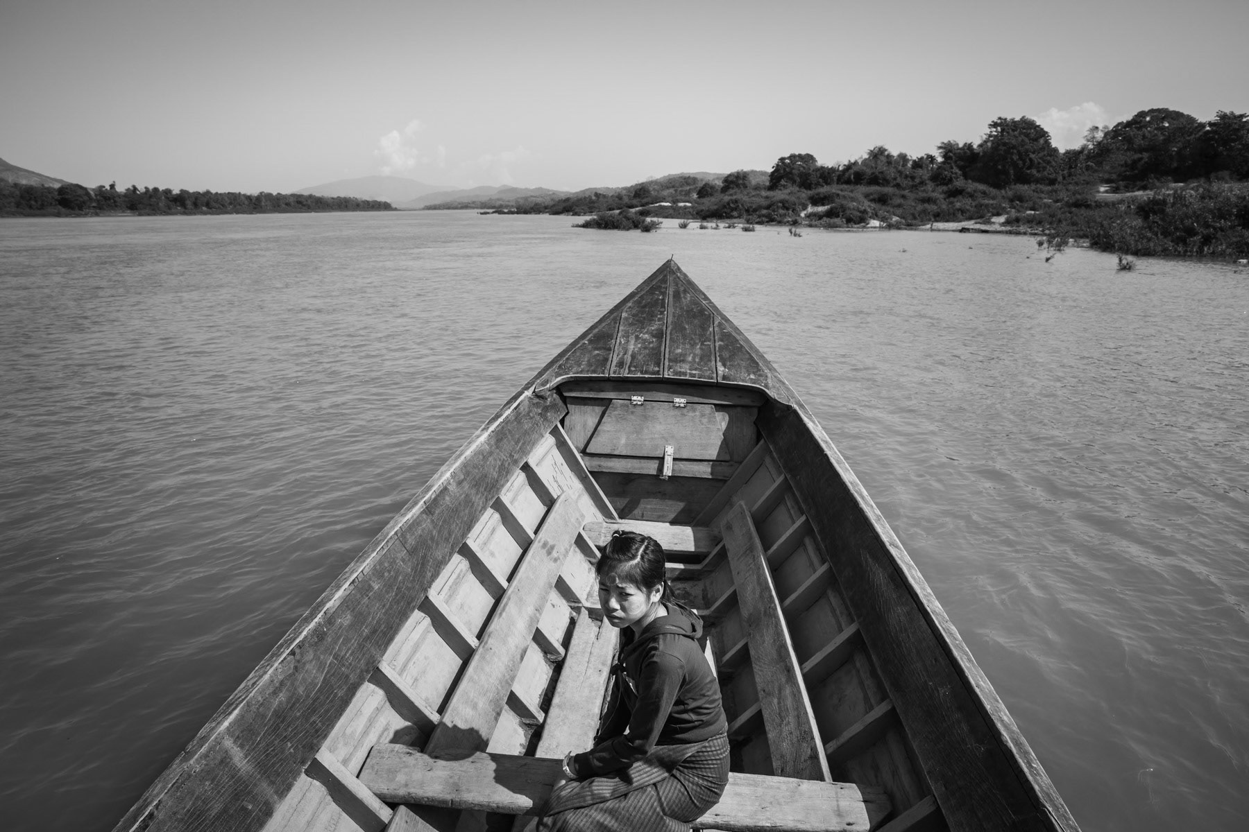 Crossing the Irrawaddy river. A controversial dam project in this area as part of the Chinese Belt and Road infrastructure projects that will undoubtly erase numerous villages along the river and deprive the local Kachin population of fertile lands. The project has been shelved but could be restarted very soon. The electricity produced by the dam would for more than 90% go to bordering Yunnan province in China. Irrawaddy river, Myitkyina, Kachin State, March 2019