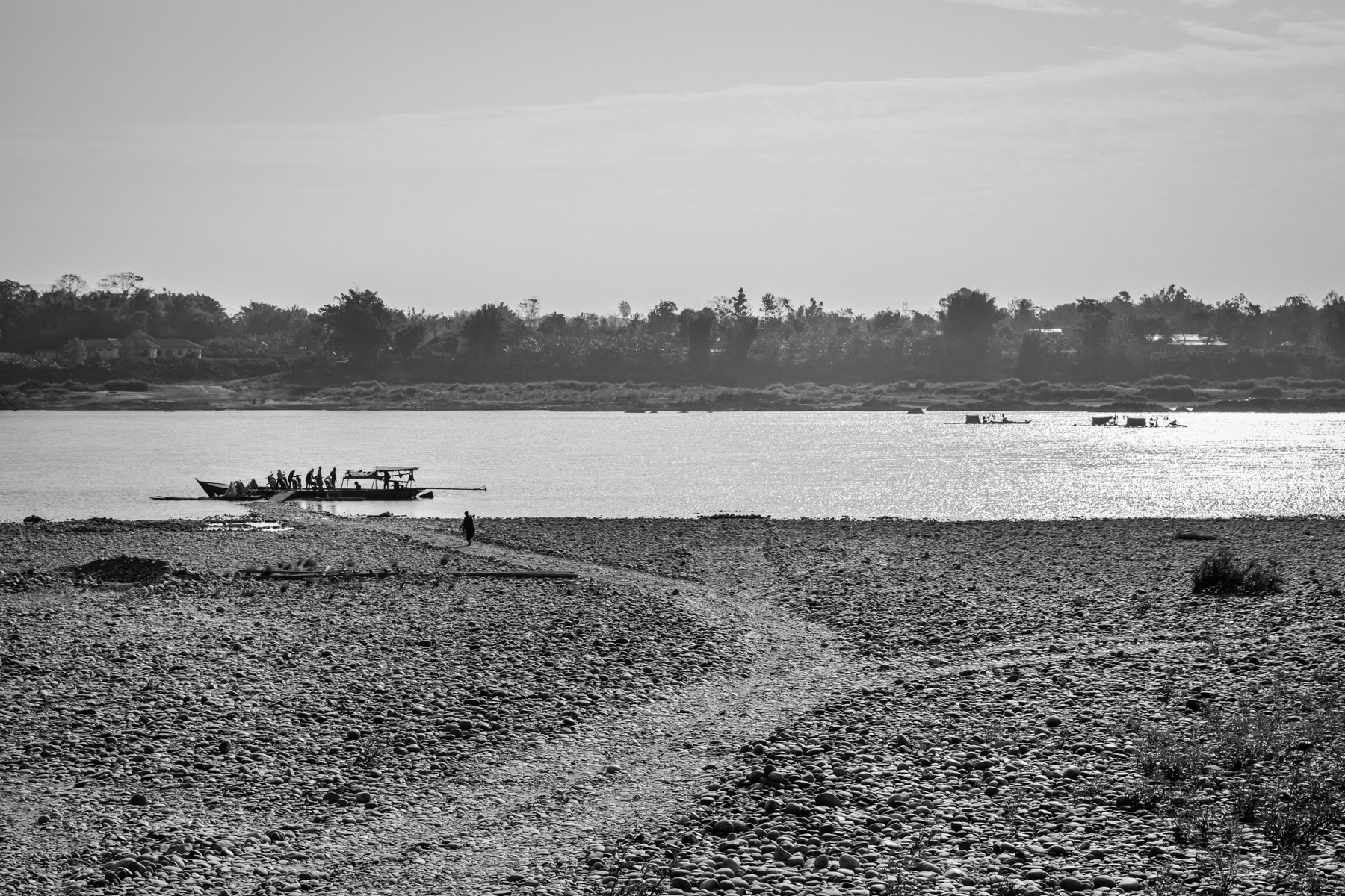A ferry boat taking passengers and their motorbikes accross the Irrawaddy river 30 Km north of the State capital and the nearest bridge. Myitkyina Township. Kachin State, Myanmar, February 2020