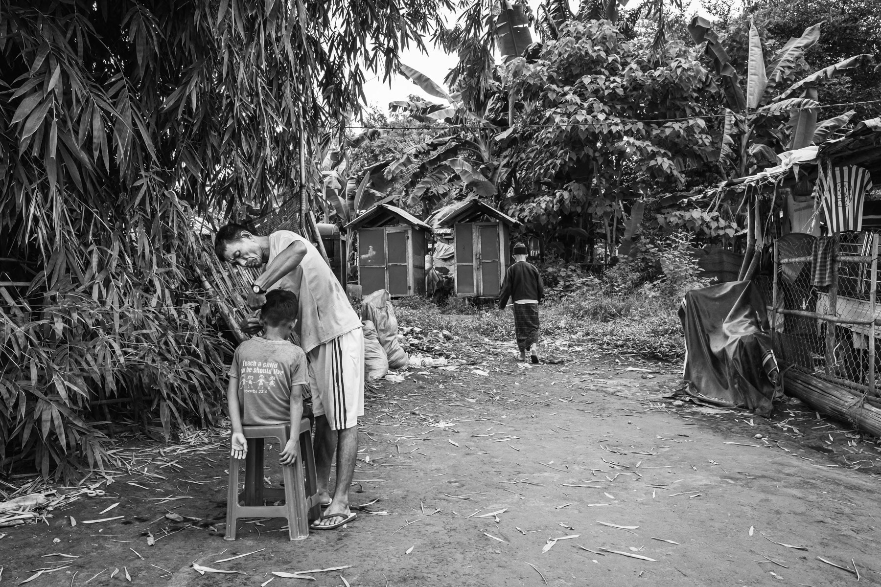 Kachin child getting his hair cut. Over 100,000 Kachin are displaced within the Kachin State since the armed conflict resumed in 2011 between the Myanmar military and the Kachin Independence Army (KIA). Jan Mai Kuang IDP camp near Myitkyina in government controlled territory, Myanmar, September 2019