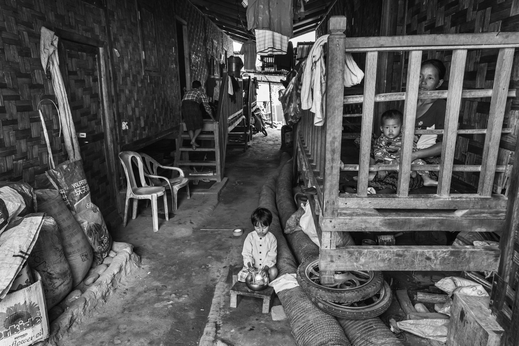 A mother and her children in a camp for internally displaced persons in Kachin Independence Organisation (KIO) held territory. KIO controlled territory stretches along the Chinese border with the frontline 20-30 miles more inland. Since the outbreak of hostilities in 2011 between the KIO and Myanmar Army, more than 100,000 people have been displaced and settled in camps in government held territories and in KIO controlled territory. Woichyai IDP camp, Laiza, KIA contolled territory in Myanmar, April 2019