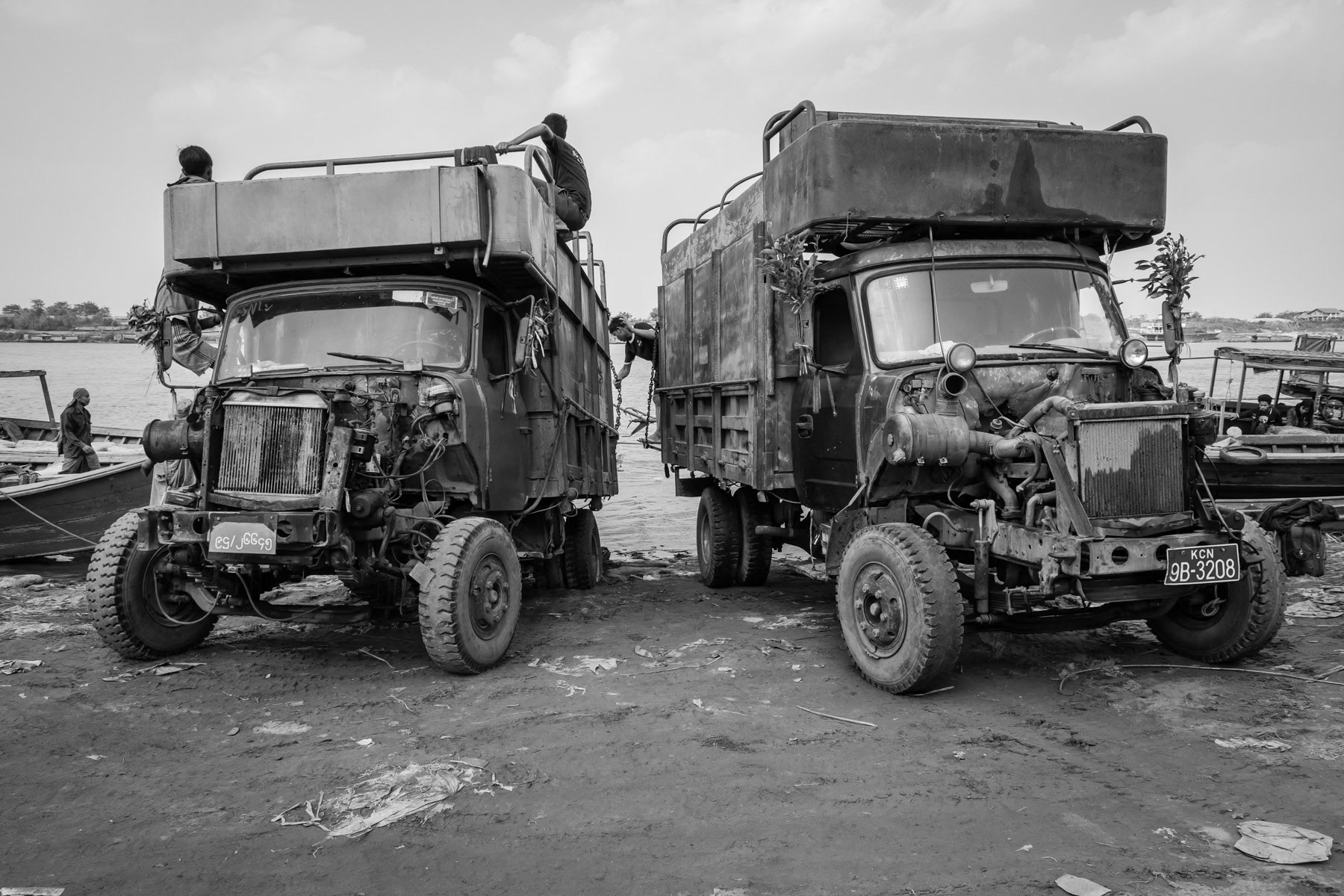 Trucks loading suplies from boats along the Irrawaddy river. The Irrawaddy river is the main cargo link through Myanmar, and also a main livelihood source for million of people from Kachin State all the way to lower Myanmar. Bhamo, Kachin State, February 2020